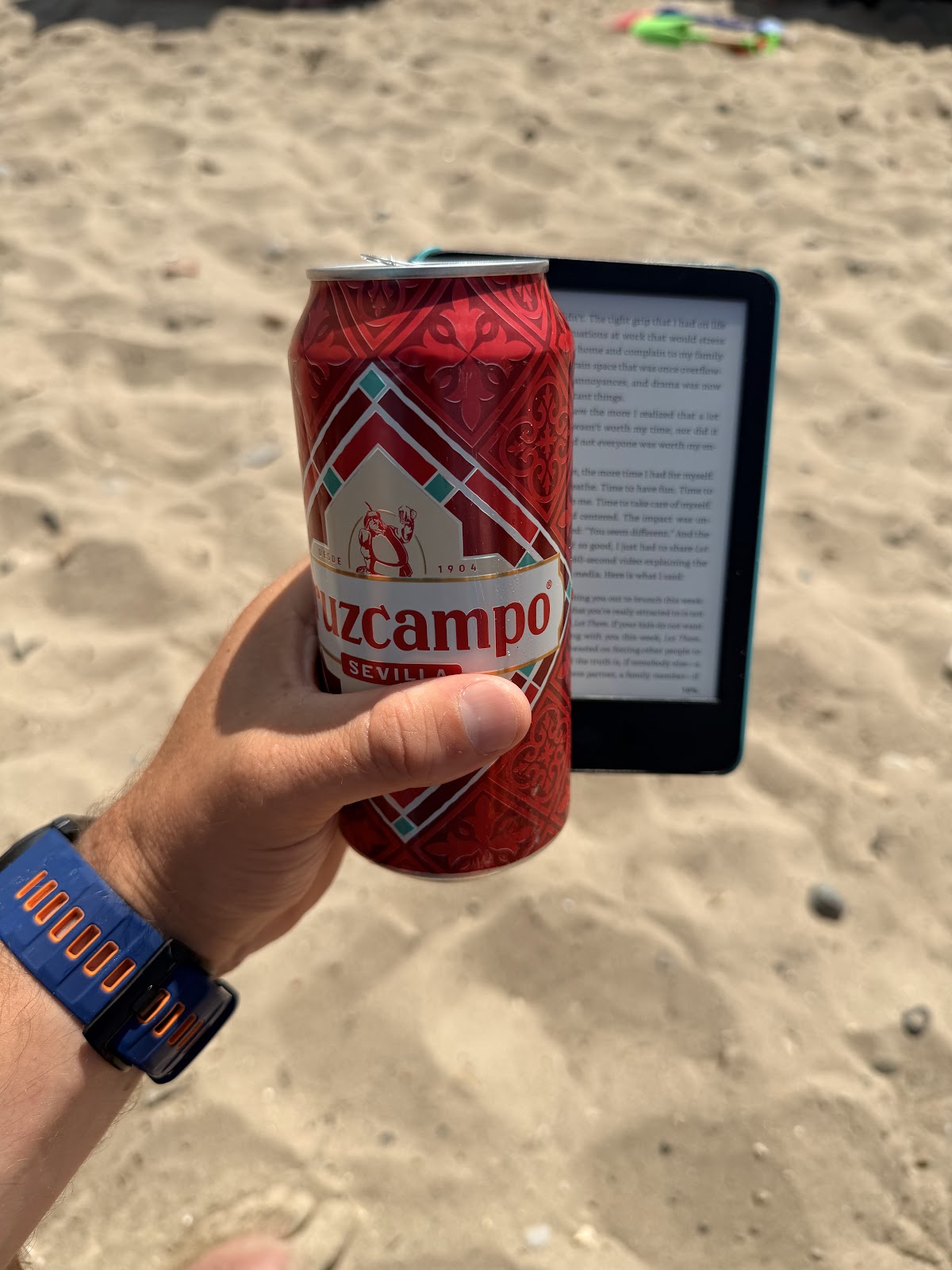 Relaxing on the beach with a book and a beer during recovery